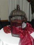 Decorative bird cage for money envelopes on wedding gift table